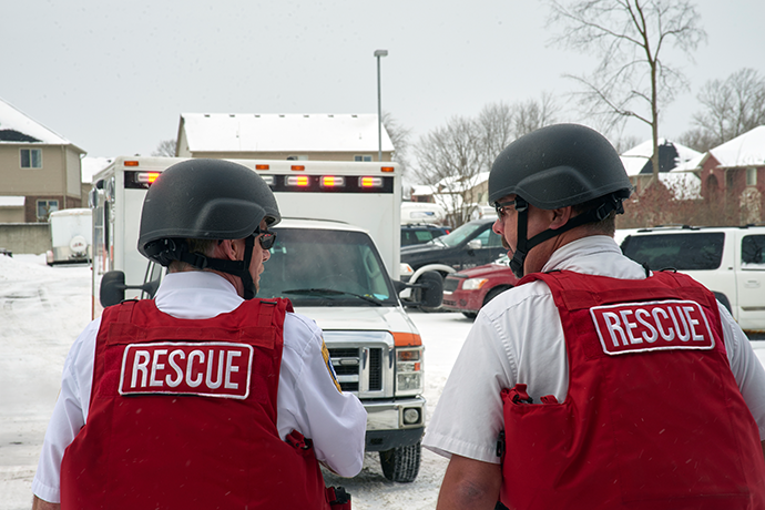 First responders in rescue gear walking toward their ambulance